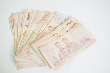 A thousand baht banknote on a white background