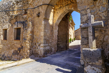 Obraz premium Medieval village with stone houses, cobblestone streets, old doors and windows, arches and walls. Maderuelo Segovia Spain. 