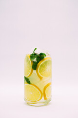 Lemonade with ice and mint on a white background