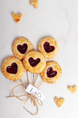 Small cherry pies pops on sticks on Valentine's Day. Top view.