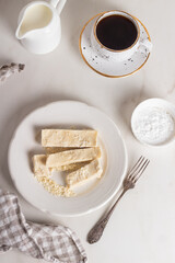 Homemade organic halva is dessert of Turkey. Sliced halva in a plate with coffee.