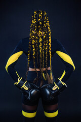 Boxing sport concept. Woman with yellow braids on black background. Girl sportsman muay thai boxer...