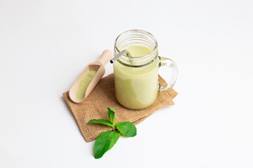 Green Tea matcha in glass mason jar and spice spatula
