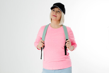 Sporty happy middle age beautiful woman with backpack isolated on white background. Copy space. Mid...
