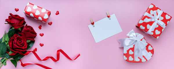 panoramic view. Heart shape Gift,  present box, white card and red rose on pink background. for banner. The concept of Valentine Day. top view, copy space