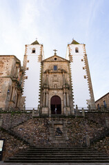 Low angle photo of a church located at Saint Jorge square in Caceres, Spain. This church has 2 main towers where people can go to see the views of the city.