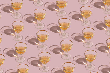 Shiny glasses on an pastel pink background. Creative pattern.