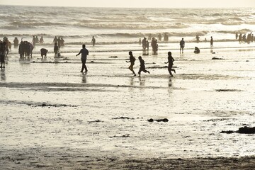 Fototapeta na wymiar children playing on the beach