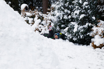 View of an snow igloo in a winter landscape and boy playing