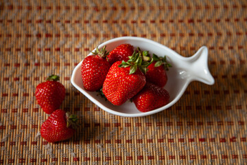 large horizontal photo. seasonal fruits on a figured plate in the form of a fish. large ripe...