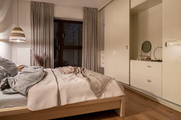 Elegant beige bedroom with wardrobe