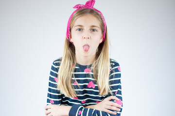 Funny blond girl stick out the tongue over white background.