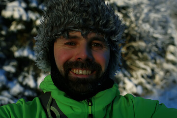 winter traveler activity, man in a fur hat with earflaps, tracking in winter