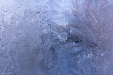 Frozen window, frosty pattern on the glass. 