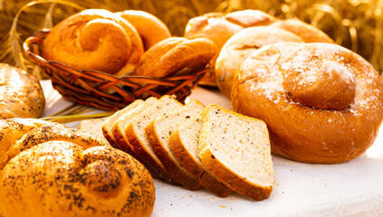lot of different flavored bread, wheat, rye, on the table in the field outside
