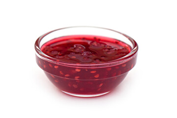 Raspberry jam in glass bowl, liquid jam isolated on white, side view, lay out with space for text
