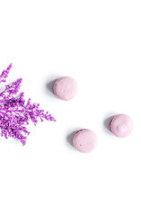 macaroons and flowers for light breakfast white desk background top view mockup