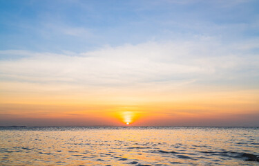 Naklejka na ściany i meble Sunset sky over sea in the evening with colorful orange sunlight sky landscape background.