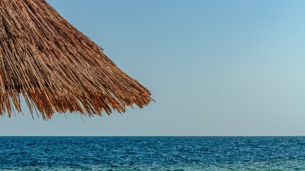 Fototapeta na wymiar Beach umbrella and nice seaview