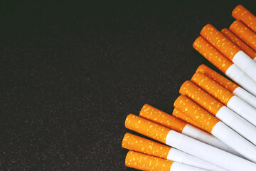 cigarettes image of several commercially made. pile on dark black. or Non smoking campaign concept, tobacco.