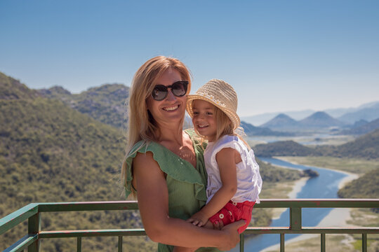 Family standing and have fun at viewpoint of Rieka Crnojevica, Montenegro. MOther with little daughter enjoy view on skadar lake.