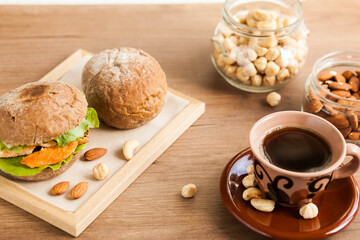 Breakfast meal. Coffee cup, sandwich and nuts. Natural products.