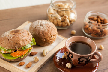 Breakfast meal. Coffee cup, sandwich and nuts. Natural products.