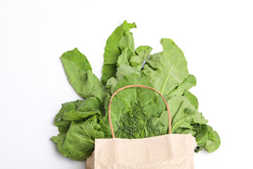 a bundle of fresh spinach on white background