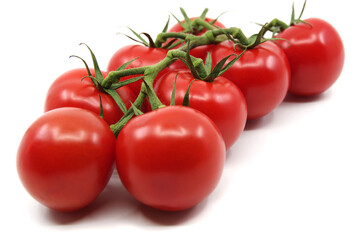 Tomatoes isolated on a white background. Red tomatoes on a twig on a white background. Tomato branch. 
