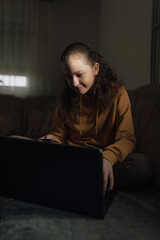 Fototapeta premium The girl is holding a bank card while shopping online