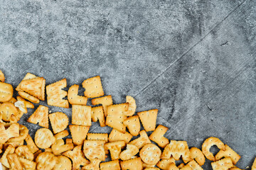 Scattered alphabet crackers on a marble background