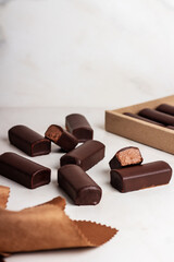 Glazed curds chocolate in a cardboard box on marble background. Dessert chocolate with glazed cheese. 