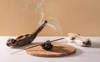 Burning aromatic incense smoky stick for meditation and relaxing on wooden minimalistic background. Aromatherapy smoke for yoga concept. - obrazy, fototapety, plakaty