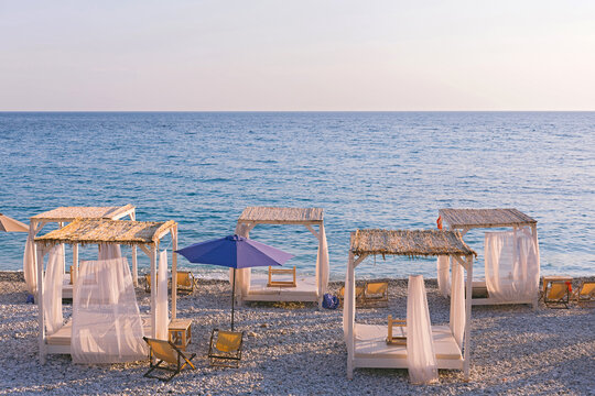 Beautiful canopies or baldachine at sea beach at the sunset. Vacation and relaxation concept.