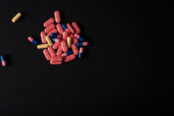 Medicine Pills. Tablets. Capsule.Pharmaceutical medicament, Close-up of pile of blue and pink tablets - capsule. Pills and tablets on black background.