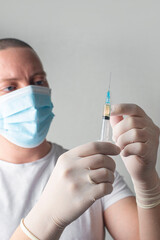 Concept fight against virus covid-19 corona virus, doctor or nurse or scientist in laboratory holding a syringe with liquid vaccines. 