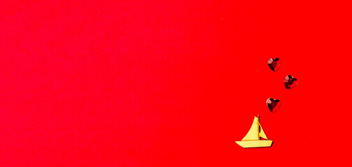 Wooden boat with a crystal heart on a red background. Saint valentine long banner. Valentine's day and wedding. Love postcard.