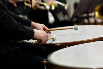 Fototapeta na wymiar Hands of a musician playing the timpani in the orchestra close up