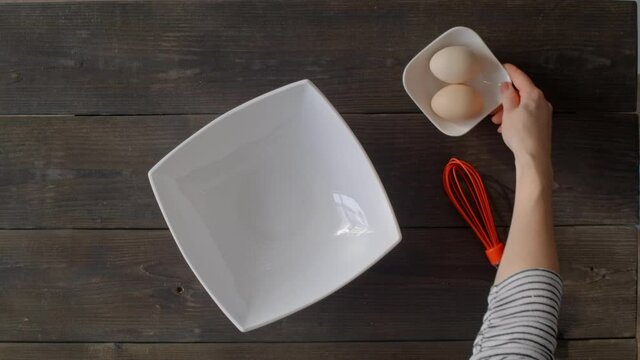 Woman's hands layout ingredients for cooking pie at home. Recipe for making fast dessert at home in the microwave. Preparing products for cooking gluten-free dessert.