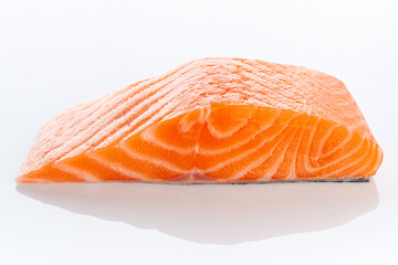Fresh raw uncooked salmon fillet slice steak isolated on white background, side view