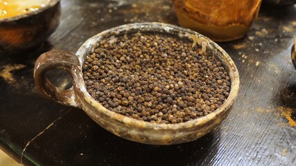 Close-up of Various Spices in Clay Pots with Wooden Spoons