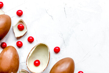 Easter chocolate eggs top view on stone background mock up