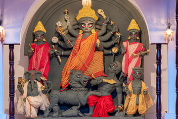 Idol of Goddess Devi Durga at a decorated puja pandal in Kolkata, West Bengal, India. Durga Puja is...