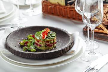 Salad of avokado, seafood, meat, vegetables and pumpkin seeds. Dietary, wholesome and tasty. Banquet festive dishes. Gourmet restaurant menu. White background.
