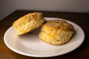Two cheese biscuits isolated on a white plate.
