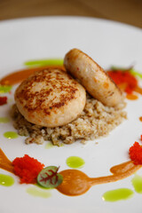 Cutlets with buckwheat and mushrooms, and sauce around. Restaurant serving dishes, close-up.