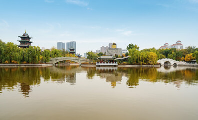 In autumn, ancient buildings and arch bridges are in Yingze Park, Taiyuan, Shanxi Province, China