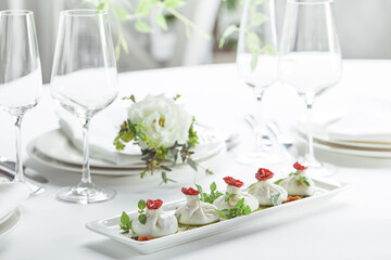 Fresh burata cheese with tomatoes and herbs on white plate