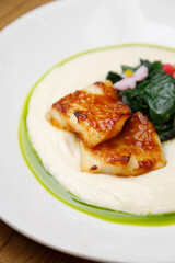 Fish dish-trout fillet in sauce and vegetables. Teriyaki fish close-up.