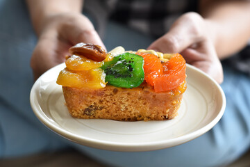 Middle view, Juicy fruit cake in ceramic dish for you.